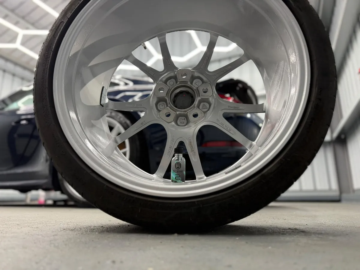 Porsche 911 with ceramic-coated paint reflecting hexagonal studio lights
