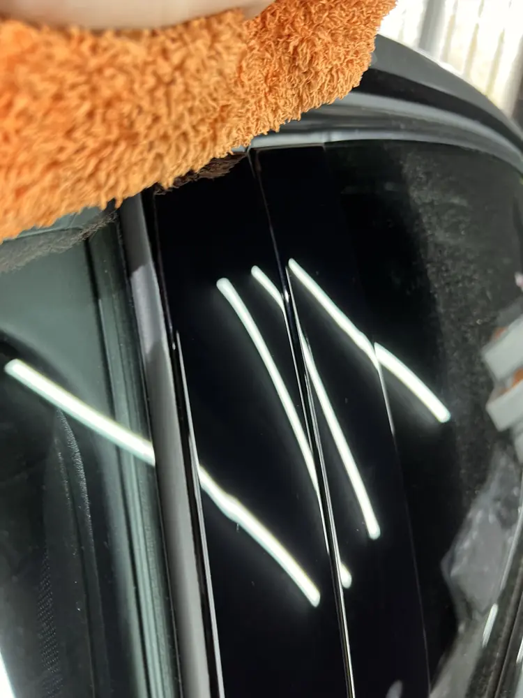 Gloss black window trim polished to a streak-free reflection